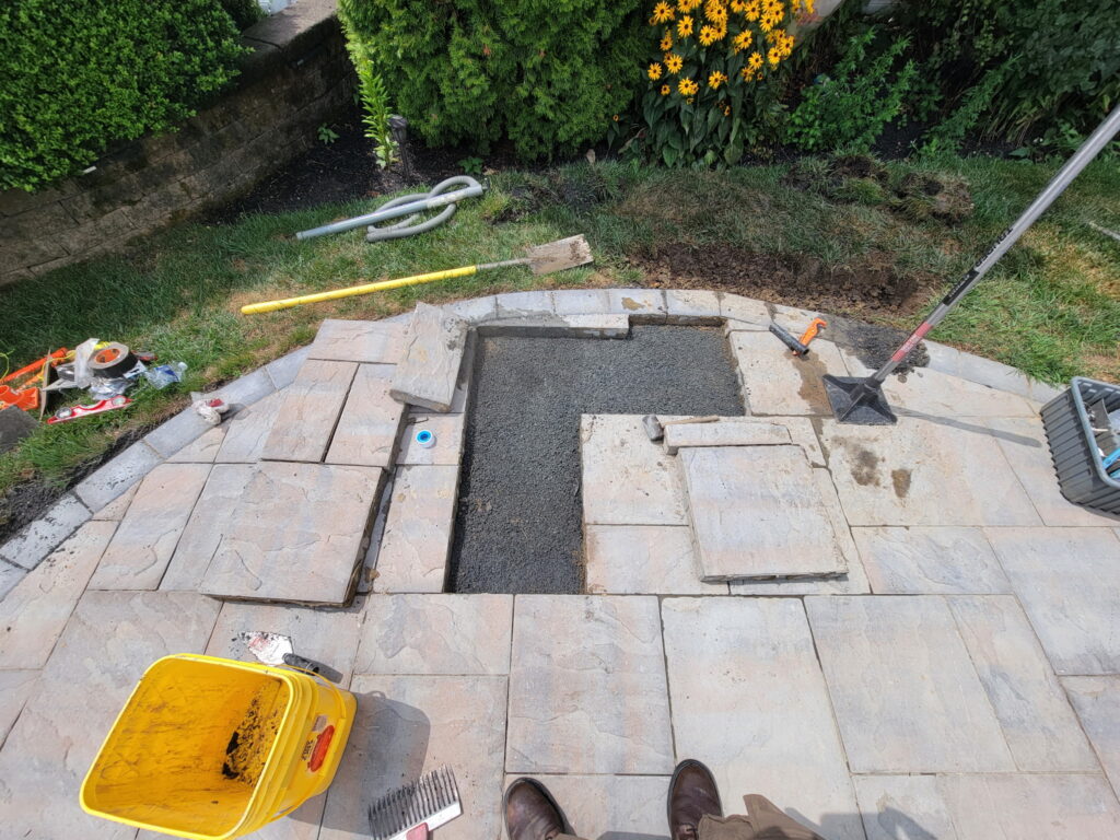 NJ irrigation repair under patio. Filling in after leak was fixed. Preparing to replace pavers.