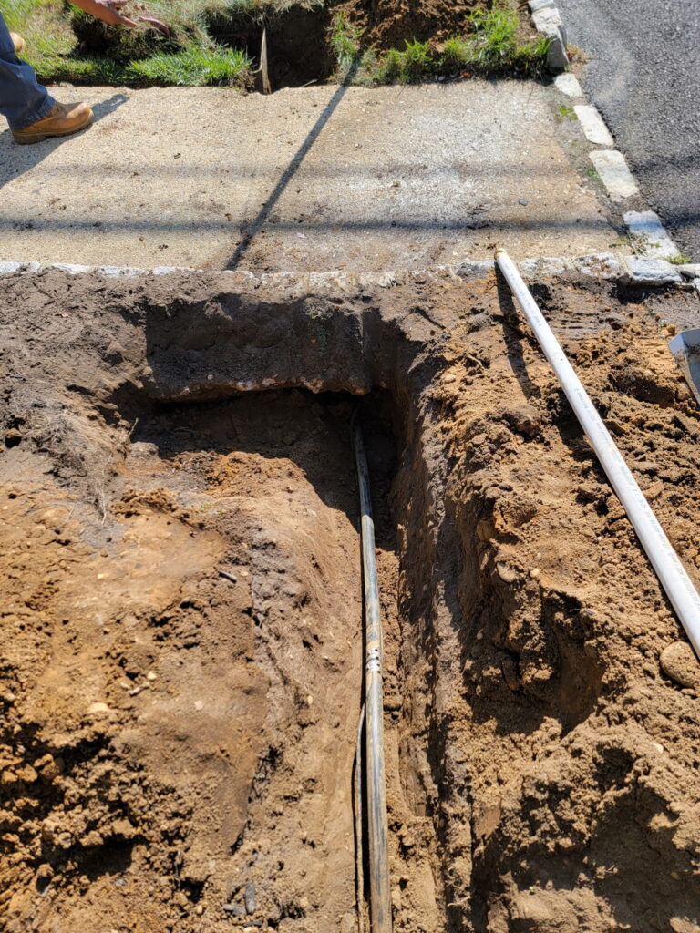 NJ irrigation repair under sidewalk. Repaired leak without tearing up sidewalk.