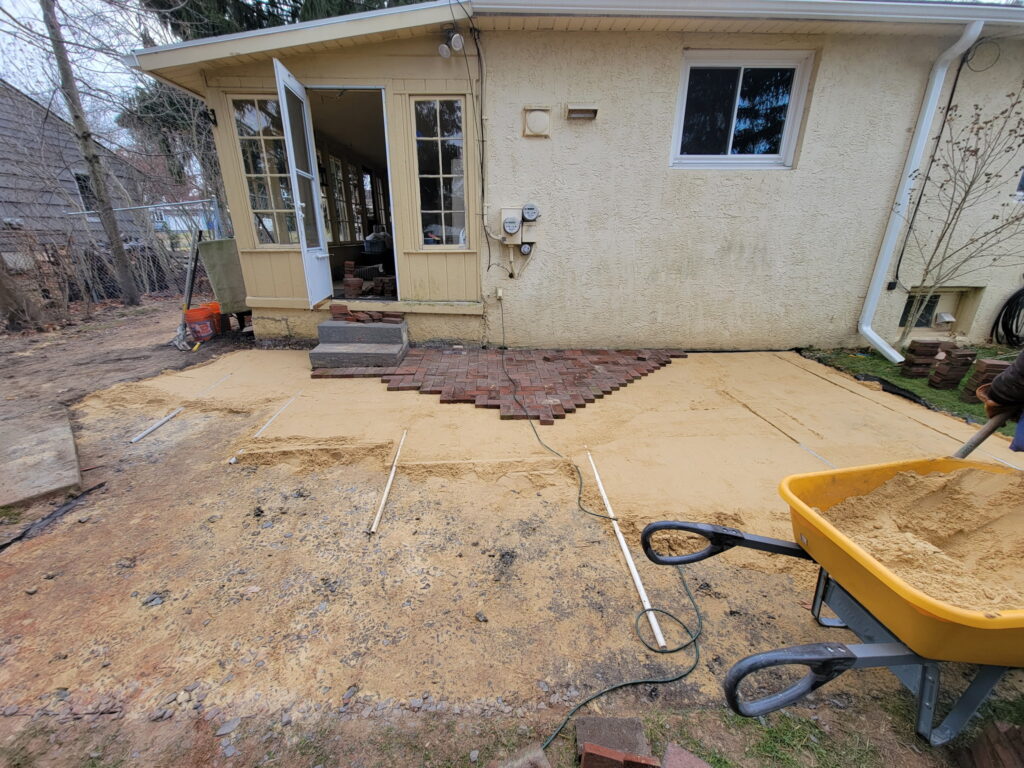 Yellow house paver bricks in process of being placed