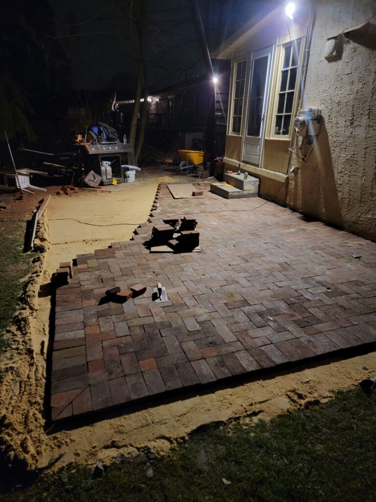 Yellow house paver bricks in process of being placed