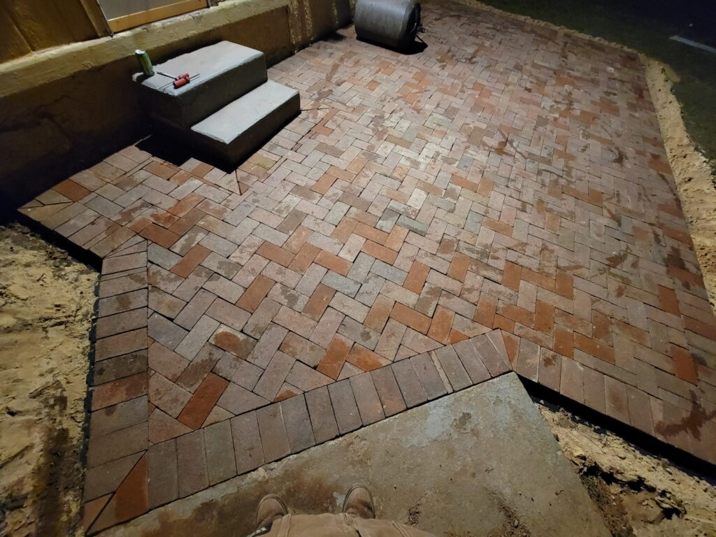 Yellow house paver installation downshot